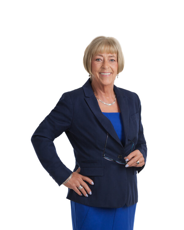 Lorna Mason — three-quarter portrait, navy blazer over royal blue